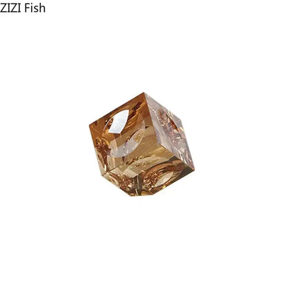 Amber-colored faceted crystal cube statue with intricate internal designs for office decorbites crystal cube desk ornament