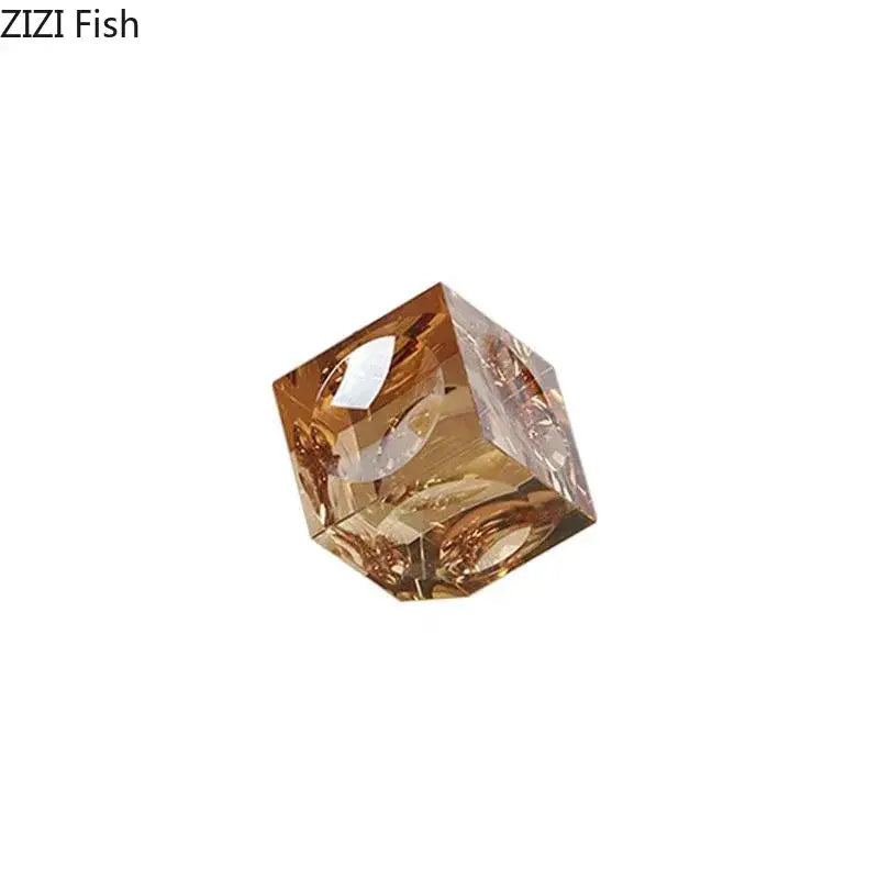 Amber-colored faceted crystal cube statue with intricate internal designs for office decorbites crystal cube desk ornament