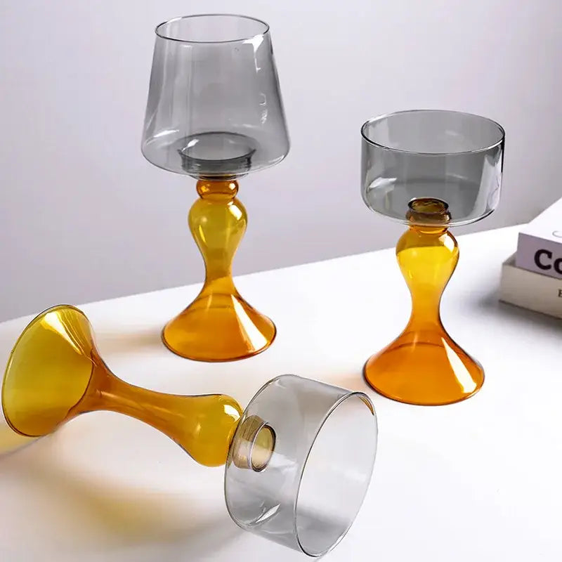 Three modern glass goblets with amber-colored stems and gray bowls for decorbites geometric glass candle holder display