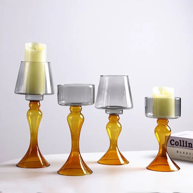 Set of four amber and gray decorbites geometric glass candle holders with tapered stems holding white led candles