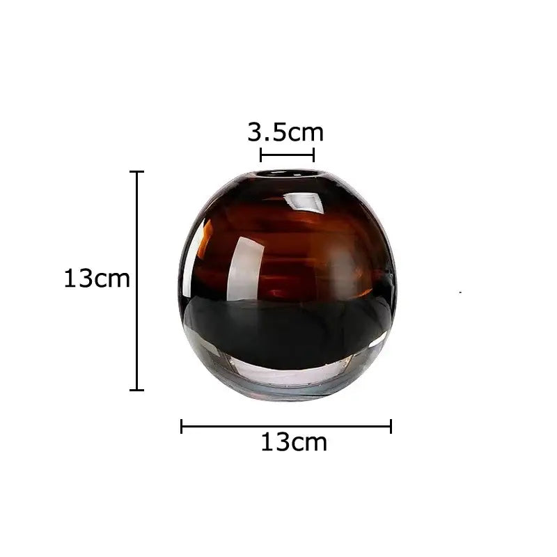 A decorbites delicate glass vase with a spherical shape and deep amber to black gradient for living room decor