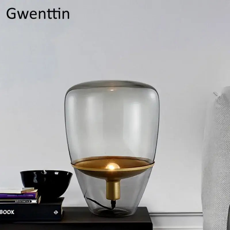 Gwenttin led table lamp with amber glass body and gold-toned brass base for elegant bedroom lighting