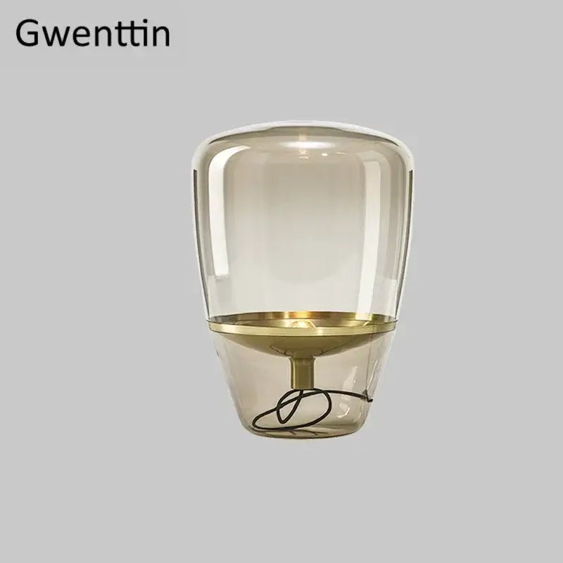 Gwenttin led table lamp with translucent amber glass shade and gold-toned metal base for bedroom lighting