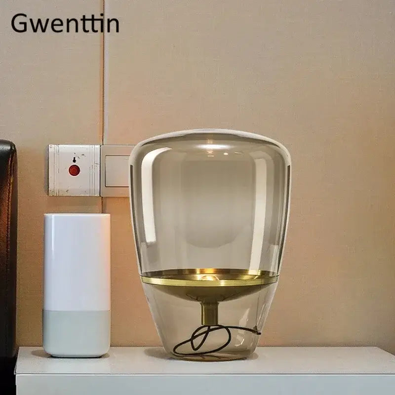 Gwenttin amber glass and brass led table lamp with a translucent amber body and gold-toned metallic base for bedroom lighting