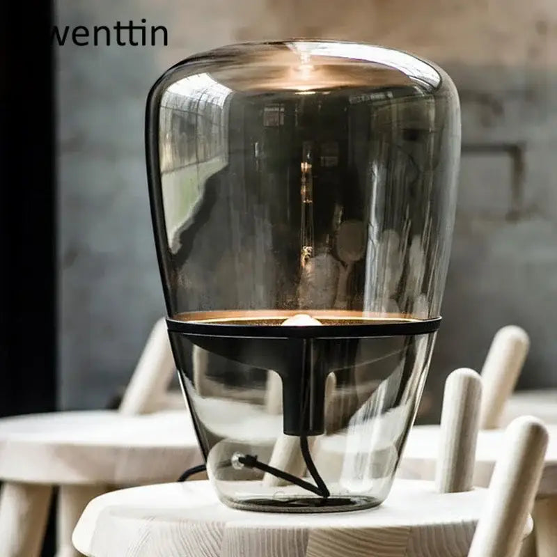 Amber glass and brass led table lamp with transparent glass body and black metal base for bedroom lighting