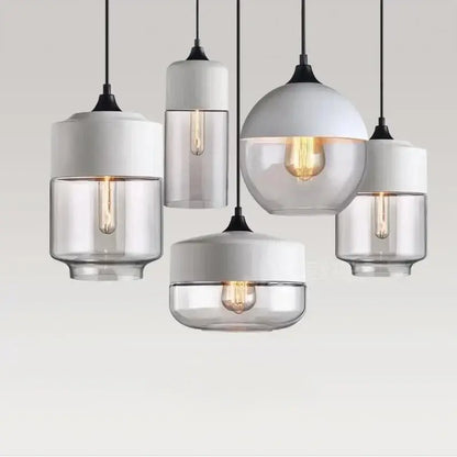 Modern pendant light fixture with amber glass shades, white ceramic tops, and warm filament bulbs for dining room
