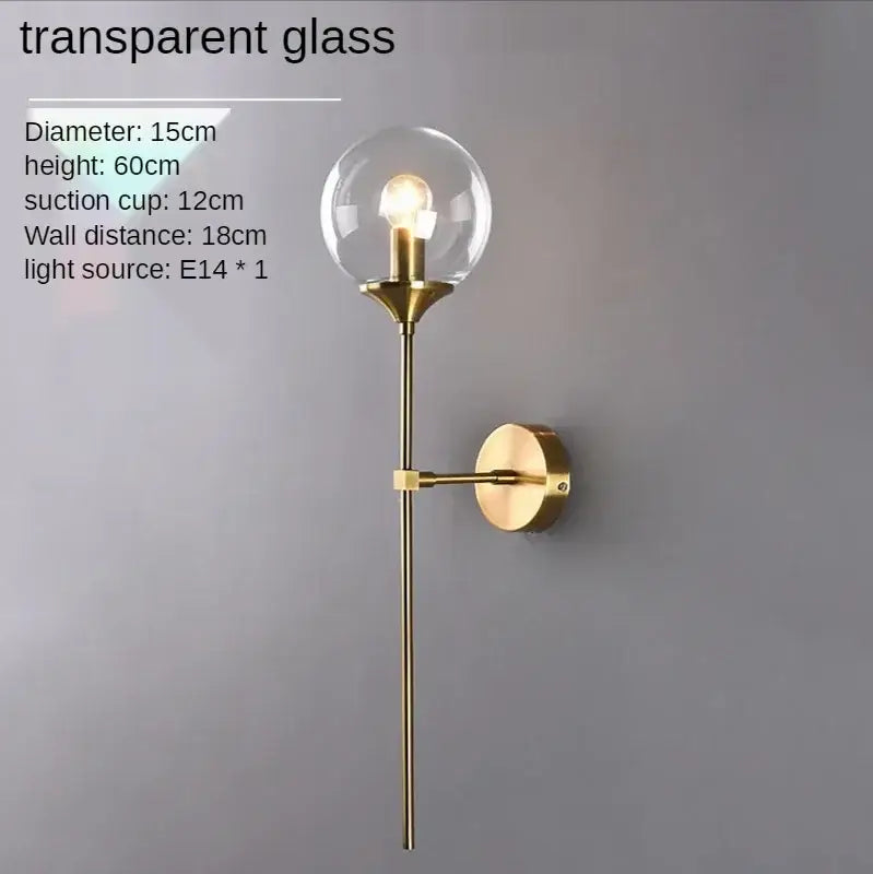 Gold-toned sconce light with amber glass ball and brass finish metal components for bedroom decorbites glass ball sconce