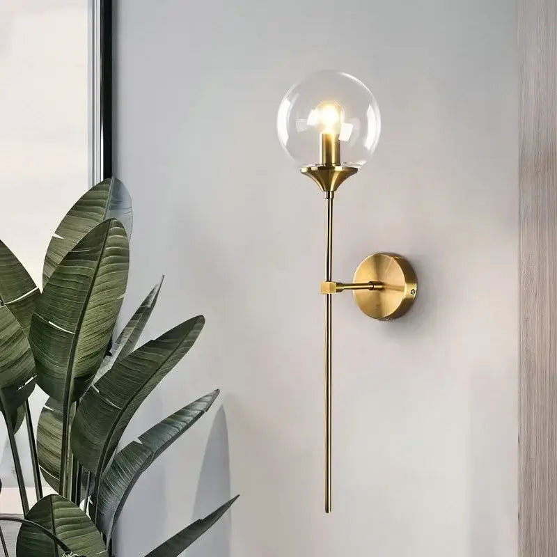 Gold-toned decorbites glass ball sconce light with clear globe and exposed filament bulb for bedroom wall decor
