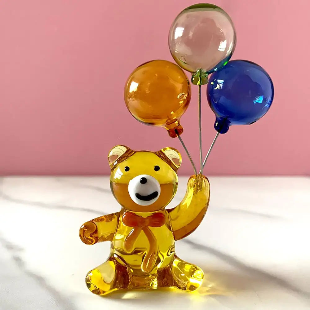 Amber glass bear with balloons glass figurine featuring translucent amber bear holding clear orange and blue balloons decorbites crystal bear