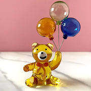 Amber glass bear with balloons glass figurine featuring translucent amber bear holding clear orange and blue balloons decorbites crystal bear