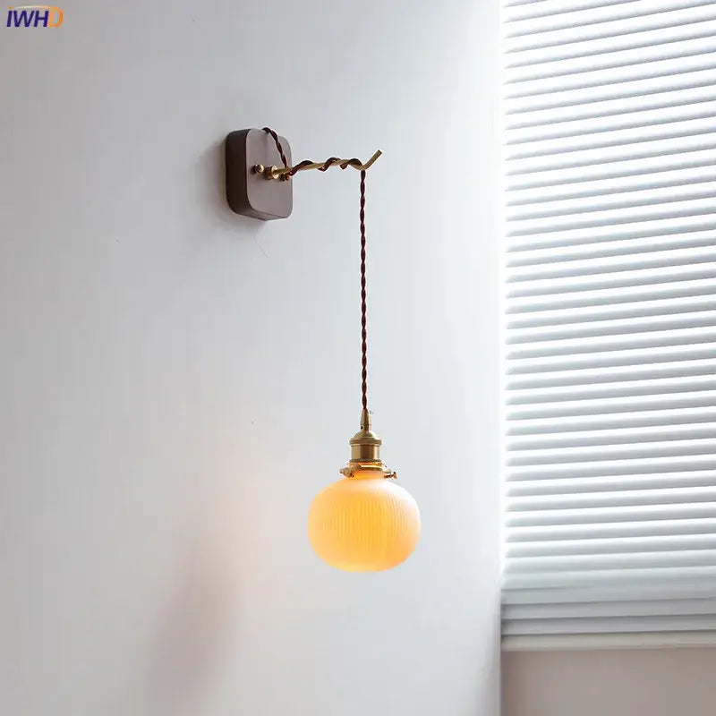 Amber glass ceramic ball led wall light with brass fixture and twisted cord for bedroom decorbites ceramic ball design