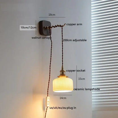 A warm-toned amber glass decorbites ceramic ball led wall light with vertical ridges and walnut canopy for bedroom decor