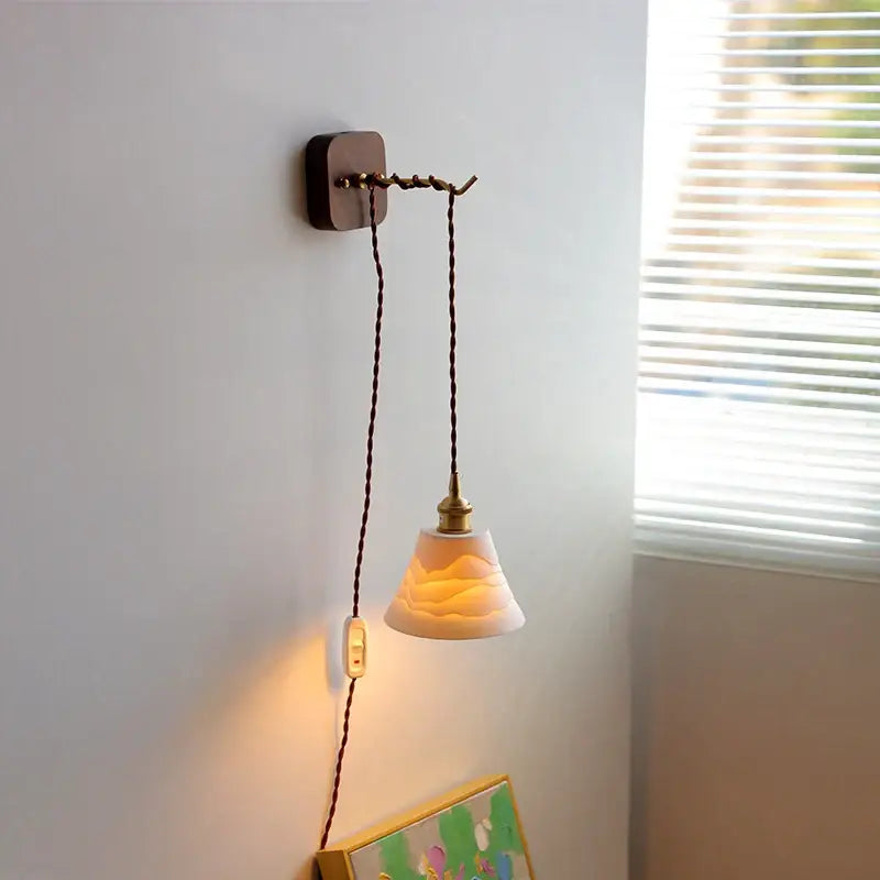 Amber glass ceramic ball led wall lights feature a warm translucent ceramic ball with subtle waves and antique brass fixture