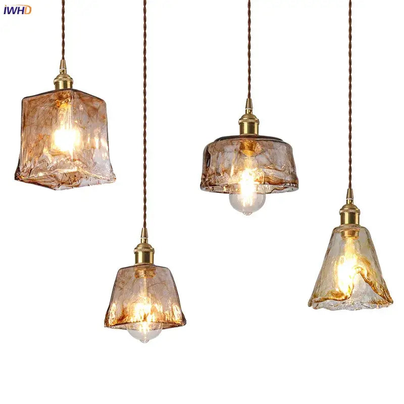 Four amber glass copper pendant lights with textured design and brass fixtures for dining room lighting set