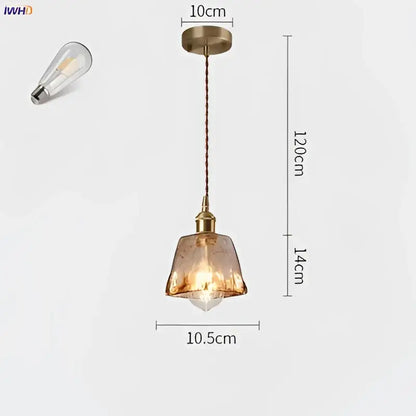 A vintage-style amber glass copper pendant light with textured shade and exposed edison bulb for dining room