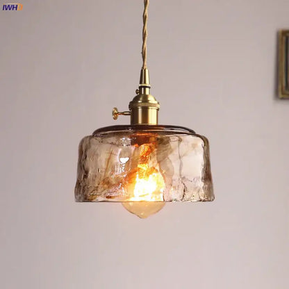 Amber glass copper pendant lights with warm-toned textured glass and brass fixtures for dining room use