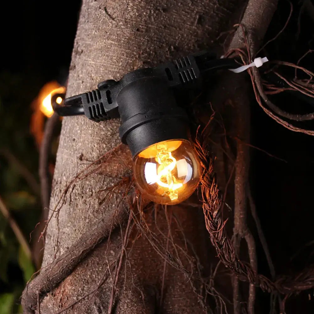 Black plastic outdoor string light with glowing amber decorbites g40 edison led bulbs for garden decor