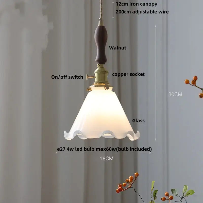 A warm amber glass led pendant lamp with frosted scalloped glass and walnut-finished iron canopy for kitchen lighting