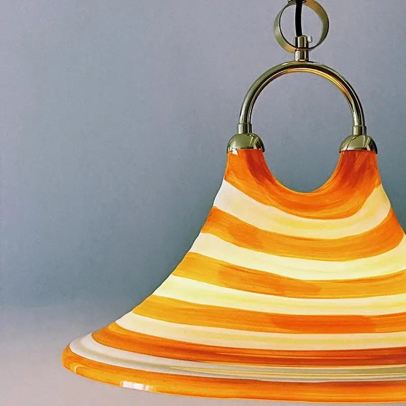 Amber glass liftable trumpet chandelier featuring vibrant orange and cream striped glass with polished brass ring for dining room decorbites liftable trumpet