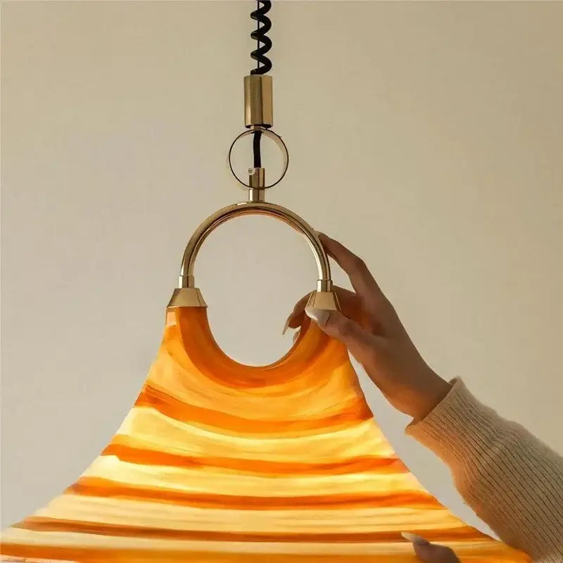 Amber glass liftable trumpet chandelier with swirling gradient and brass hardware for dining room by decorbites liftable