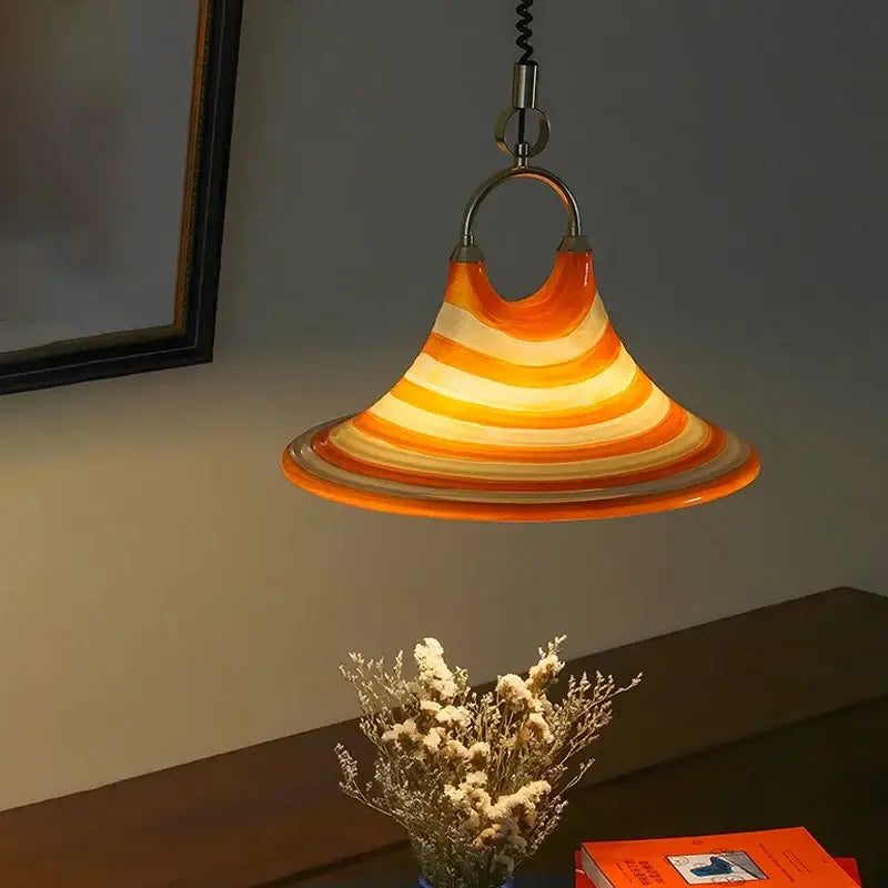 Amber glass liftable trumpet chandelier featuring a warm conical pendant lamp with orange and cream stripes for dining room decorbites liftable trumpet