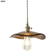 Amber glass pendant light with brass knob switch and twisted cord for dining room decor featuring decorbites brass knob