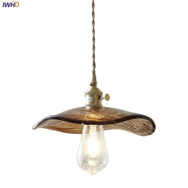 Amber glass pendant light with brass knob switch and twisted cord for dining room decor featuring decorbites brass knob