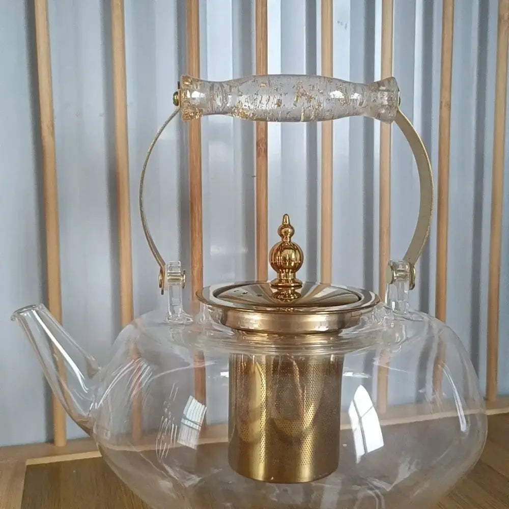 Amber glass teapot with gold infuser clear glass body and gold-toned metal lid handle and built-in filter for kitchen use