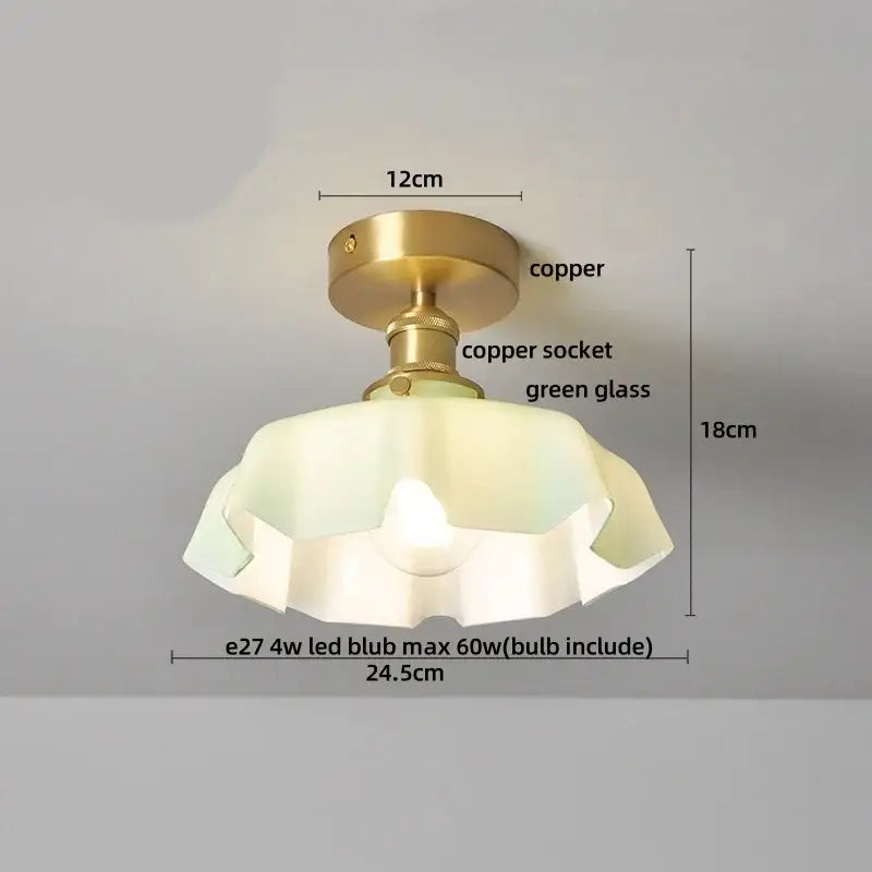 A vintage-style copper led ceiling light with a brass copper finish and translucent green glass shade with ruffled edges