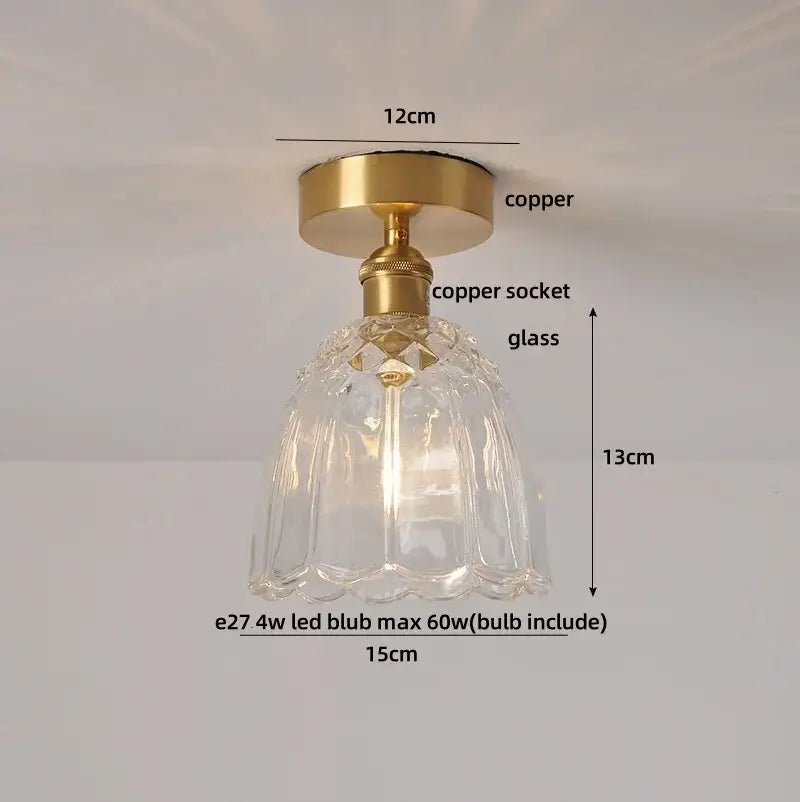 A clear faceted glass ceiling light with brass copper socket and wood copper led base for dining room use