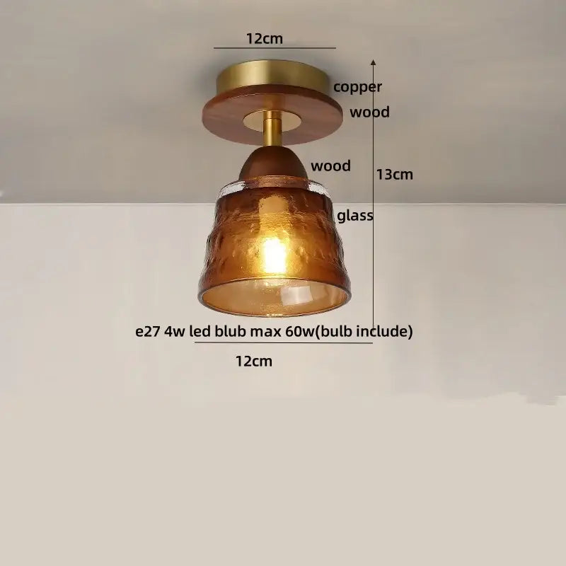 A warm amber glass ceiling light with hammered texture, wood copper led base, and wooden accents for dining rooms