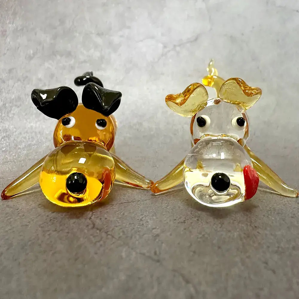 Two hand-blown glass crystal cartoon puppy figurines in amber and clear with gold accents for puppy figurine table decor