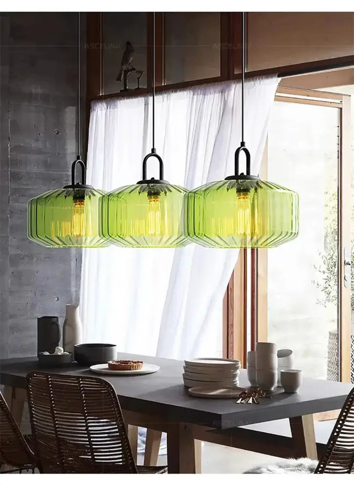 Three hanging pendant chandelier with faceted green glass led pendant shades and black metal fixtures for kitchen lighting