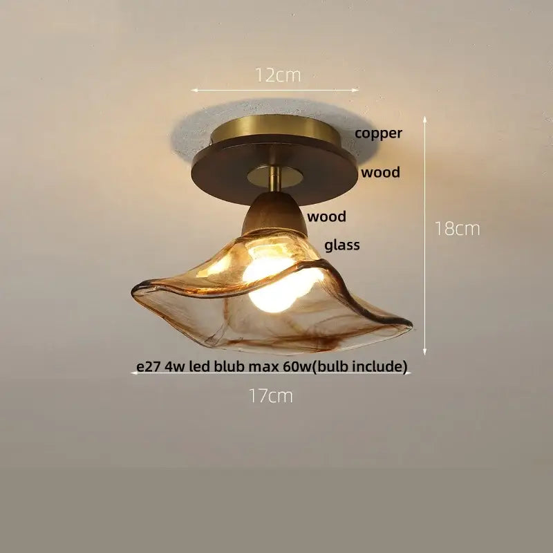 A warm amber ice crack glass ceiling light with copper and wood fixture featuring an elegant curved design