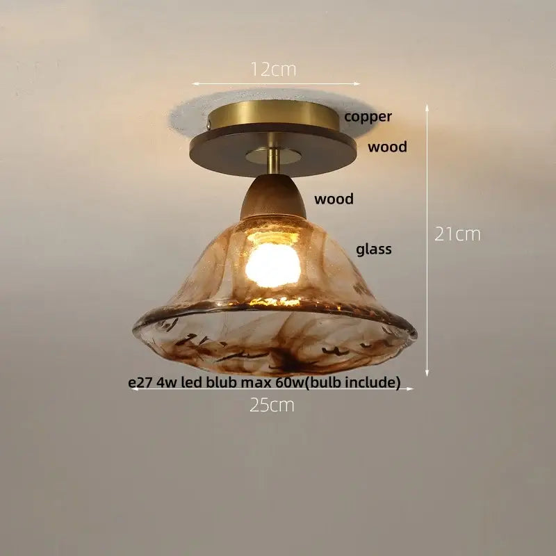 A warm amber glass ceiling light with copper and wood fixture featuring decorbites amber ice crack design