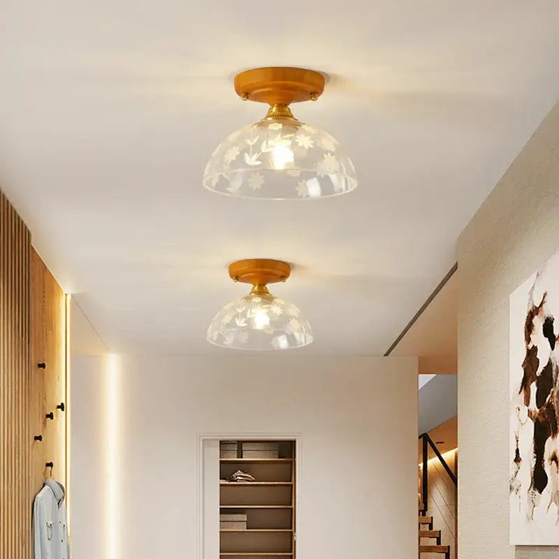 Two matching amber leaf brass glass ceiling lamps with warm wooden fixtures and etched floral glass shades for bedroom decorbites brass glass ceiling lighting