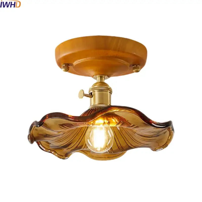 Amber glass leaf ceiling lamp with brass glass ceiling mounting base and exposed bulb for bedroom decorbites brass glass
