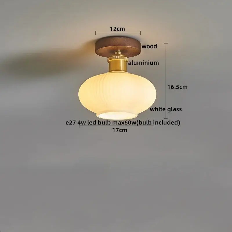 Amber leaf brass glass ceiling lamp with round wooden base, brass-colored aluminum stem, and oval white glass shade for bedroom decorbites brass glass ceiling
