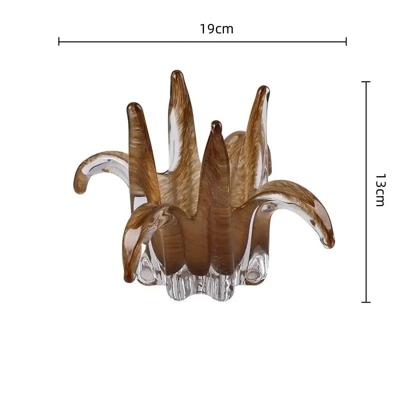 Translucent amber glass petal candle holder with a stylized leafy design for elegant living room decor