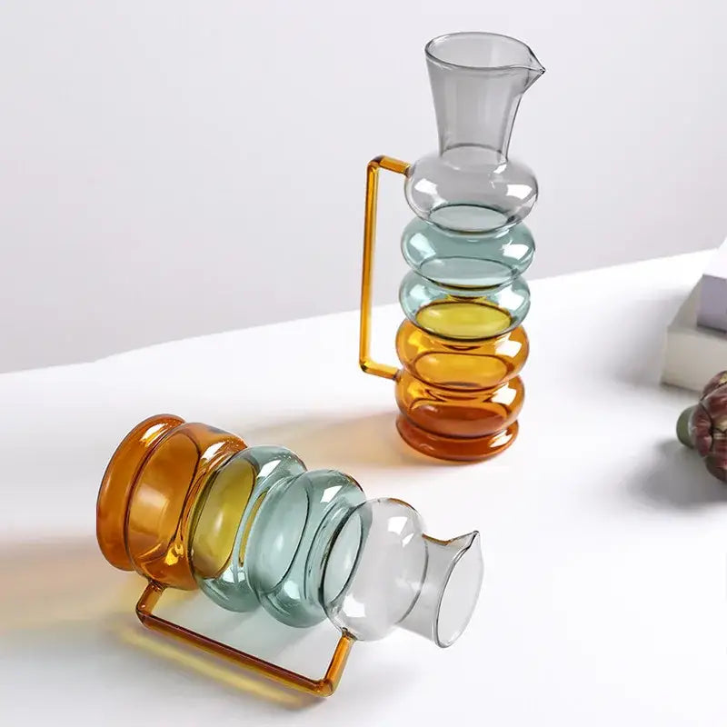 A modern amber and teal glass bubble ring vase with a stacked design and orange metallic handle for living room decorbites decor