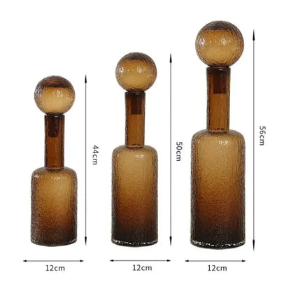 Set of three amber textured decorbites clear glass decanters with spherical stoppers for living room decor