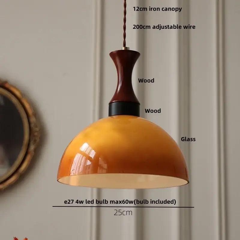 Warm amber glass pendant light with dark wood and black metal fixture featuring twisted copper cord for kitchen decorbites amber led