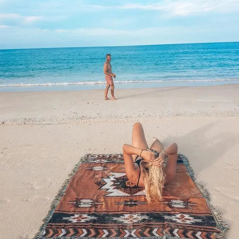 A brown patterned american country plaid beach blanket sofa cover with fringed edges and geometric designs