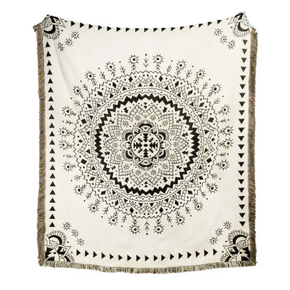 A cream-colored throw blanket with a detailed black mandala design and fringe edges, ideal as a beach blanket sofa cover