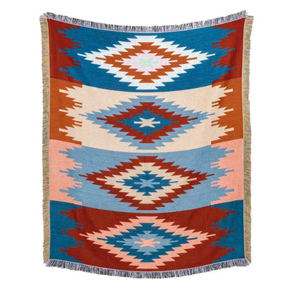 A woven american country plaid blanket sofa cover with blue terracotta and cream geometric diamonds and fringed edges