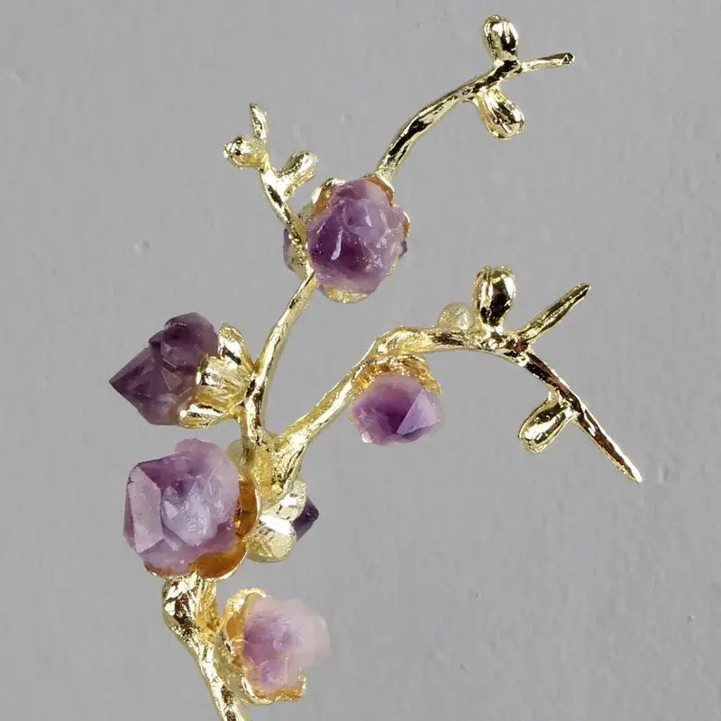 Delicate gold-toned brass tree ornament featuring faceted purple amethyst stones as a living room lucky crystal sculpture