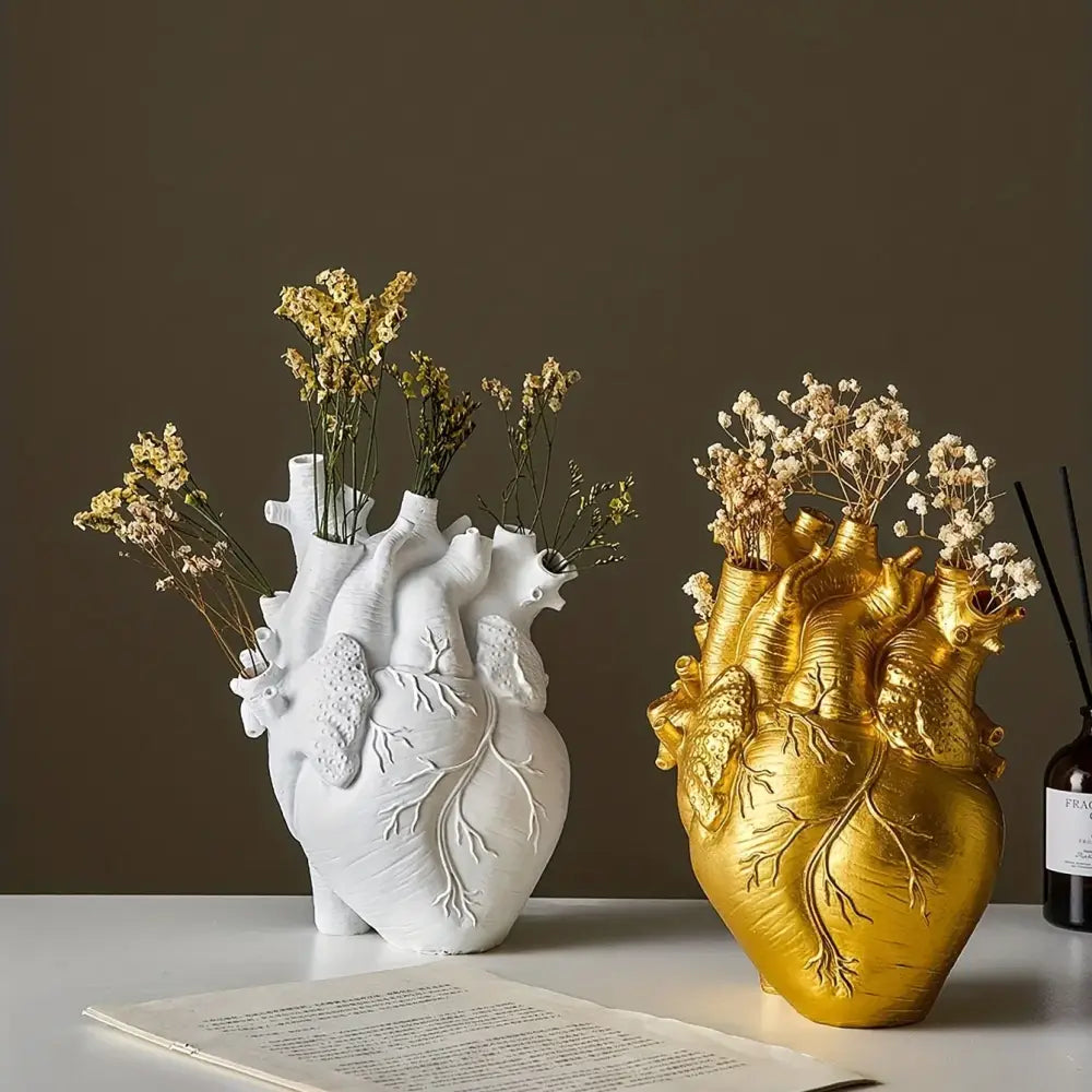 White and gold anatomical heart resin vases holding delicate dried flowers for glam decor and display use