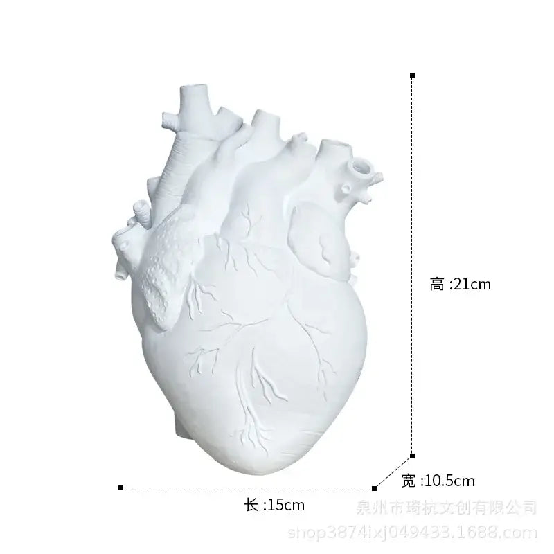 White ceramic heart shape vase with detailed anatomical features ideal for living room decor by decorbites heart shape