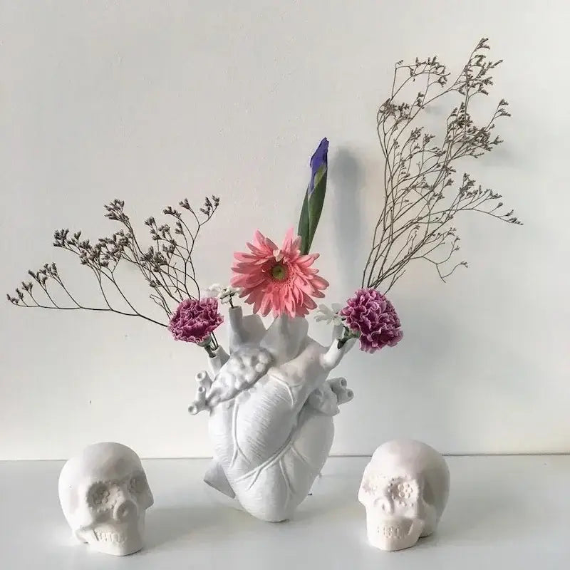 White DecorBites anatomy heart vase with realistic texture holding pink and purple flowers as a unique heart vase gift
