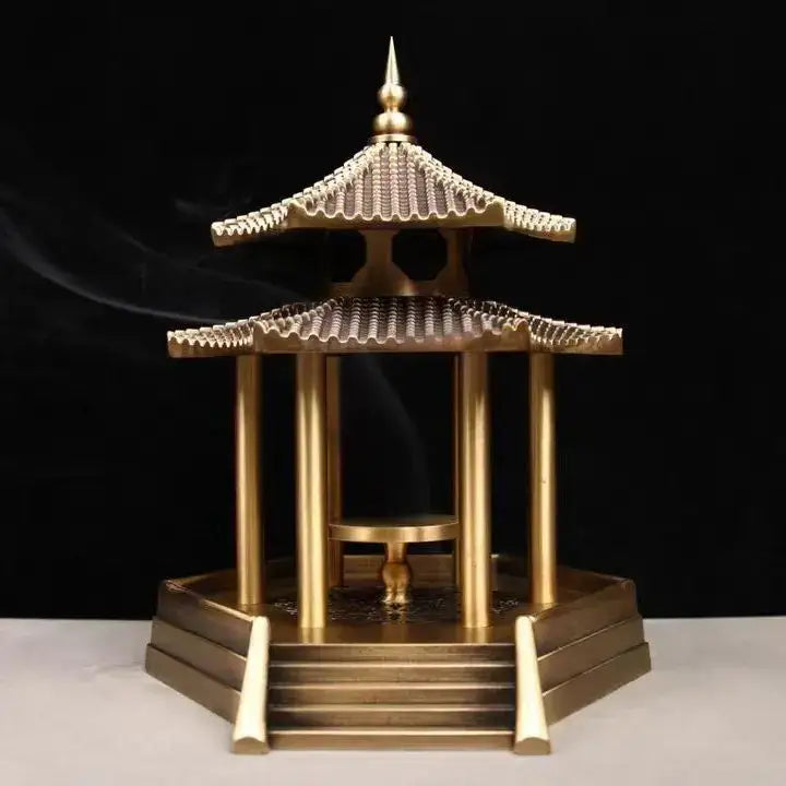 Golden brass incense burner shaped like a traditional chinese pavilion with intricate roof details and steps for decor